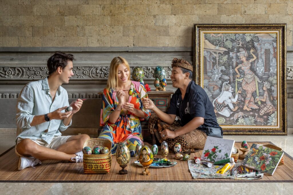 A couple and a coach in Egg Painting Class at Sakti Garden Resort and Spa