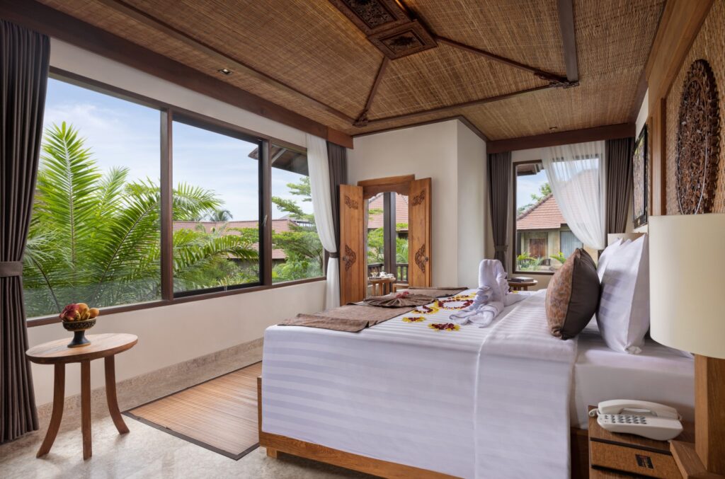 a bed sitting in a bedroom next to a window